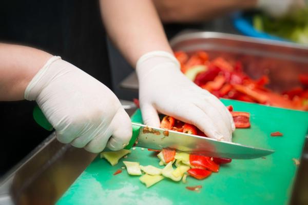 Team member cutting peppers