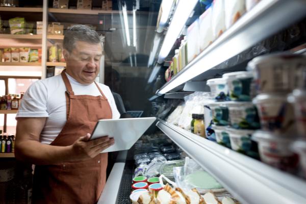 Employee checking cooler temperature