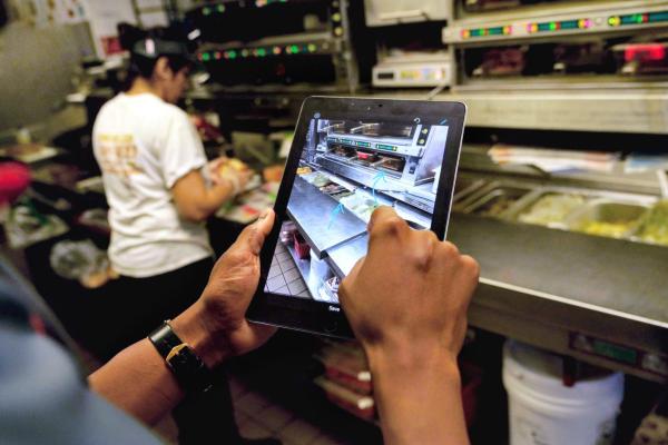 Restaurant team member using a tablet to streamline processes