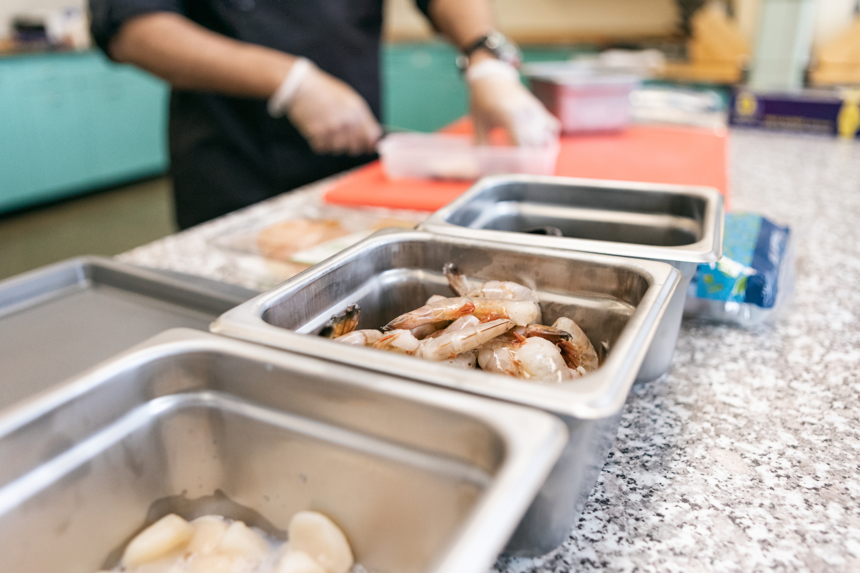 A worker prepping food.