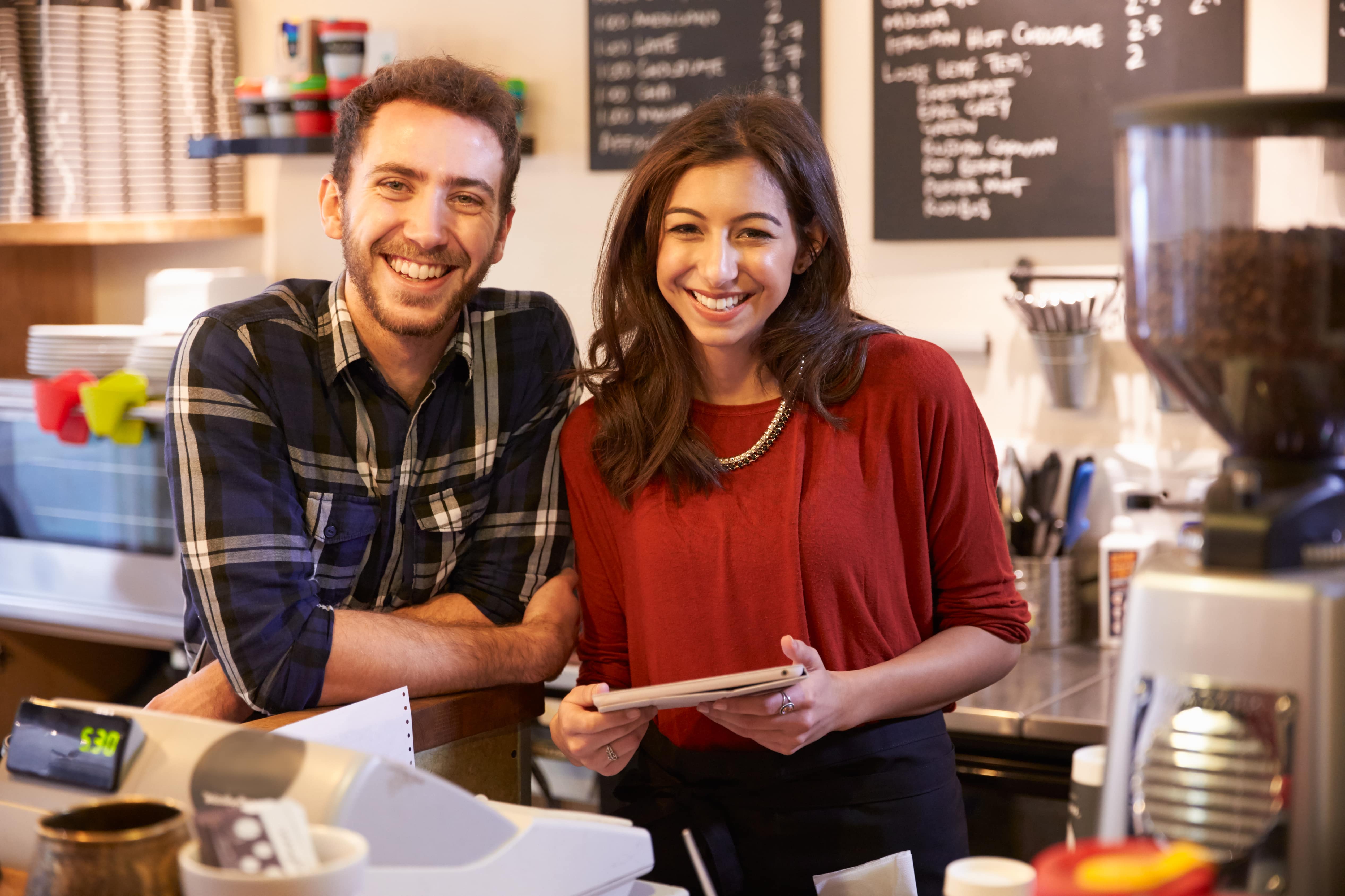 man and woman holding tablet