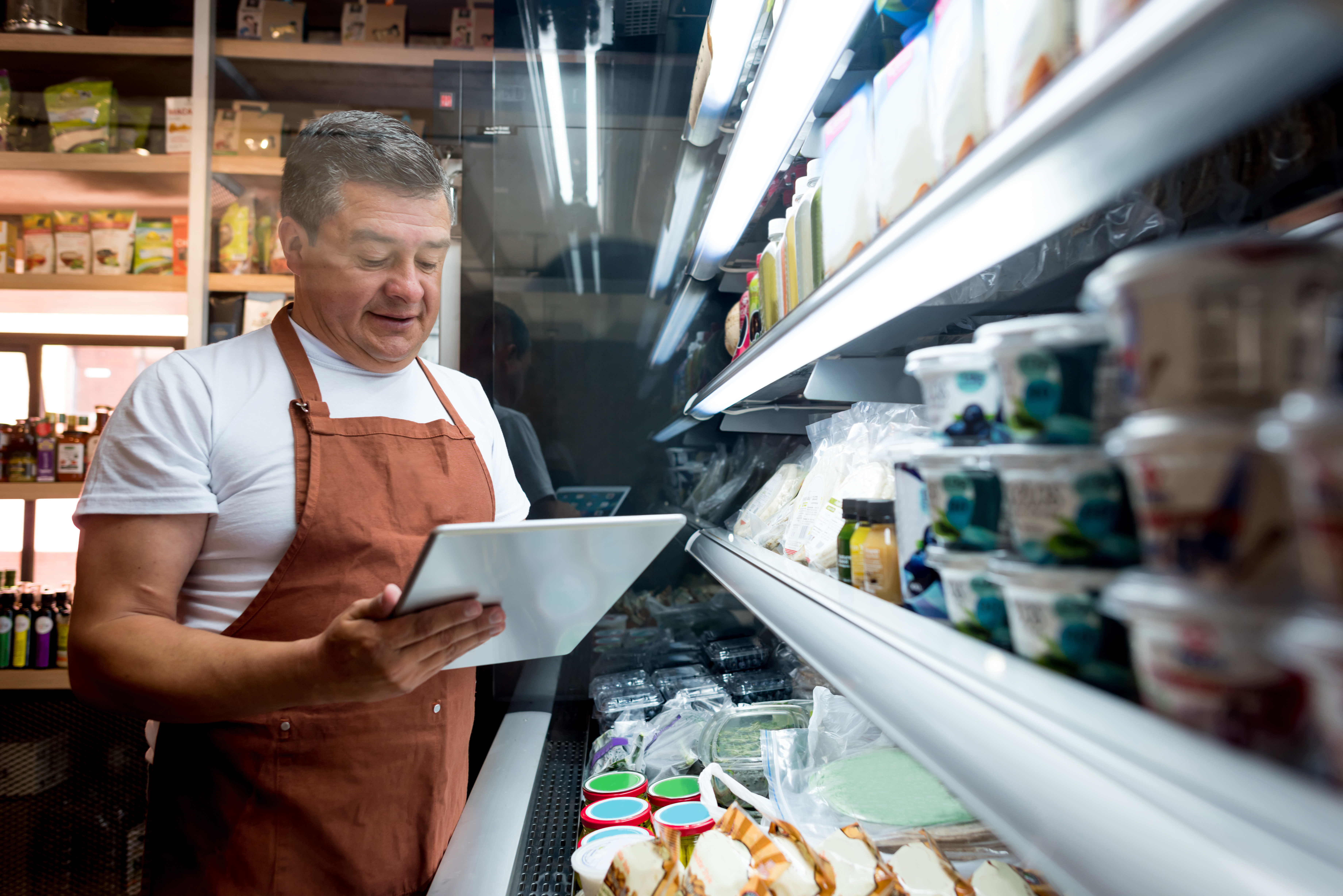a worker checking food with a tablet