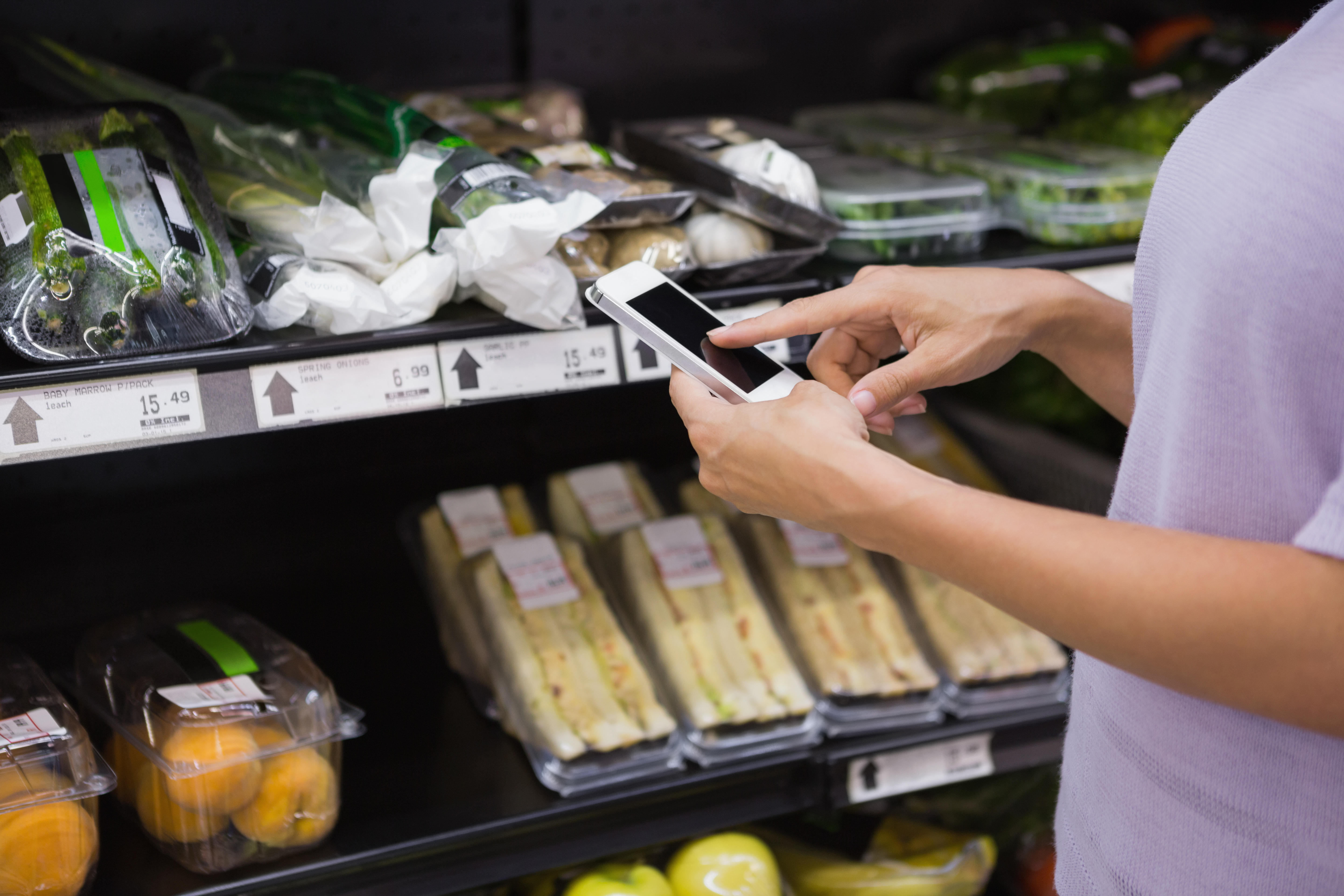 using an iphone in a grocery aisle