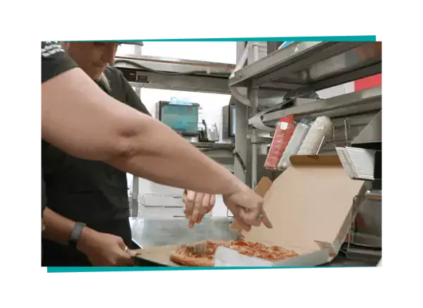Employee checking pizza