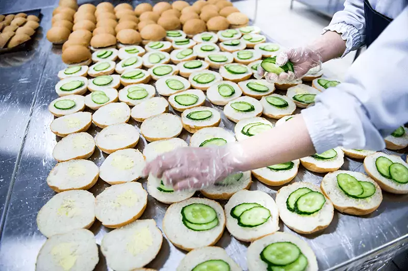 A line of sandwiches being prepared